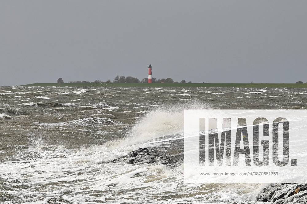 Pellworm, Schleswig-Holstein, Germany, October 25, 2026: Storm on the North Sea; lighthouse seen from the deep-water pier