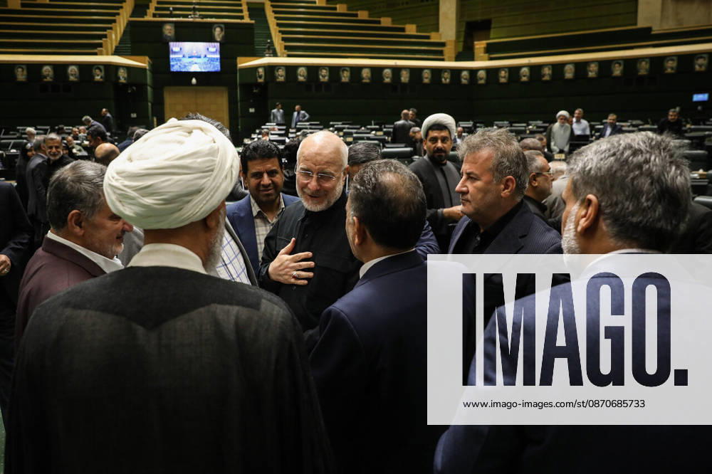 Mohammad Bagher Ghalibaf places a hand on his chest while speaking with a group of lawmakers in the chamber at the Islamic Consultative Assembly in Tehran, Iran, on October 25, 2026. The Iranian parliament held a hybrid open sitting, with some lawmakers attending in the Tehran chamber and others participating remotely, according to parliamentary reports. Tehran Iran - ZUMAi98_ 20261025_zih_i98_038
