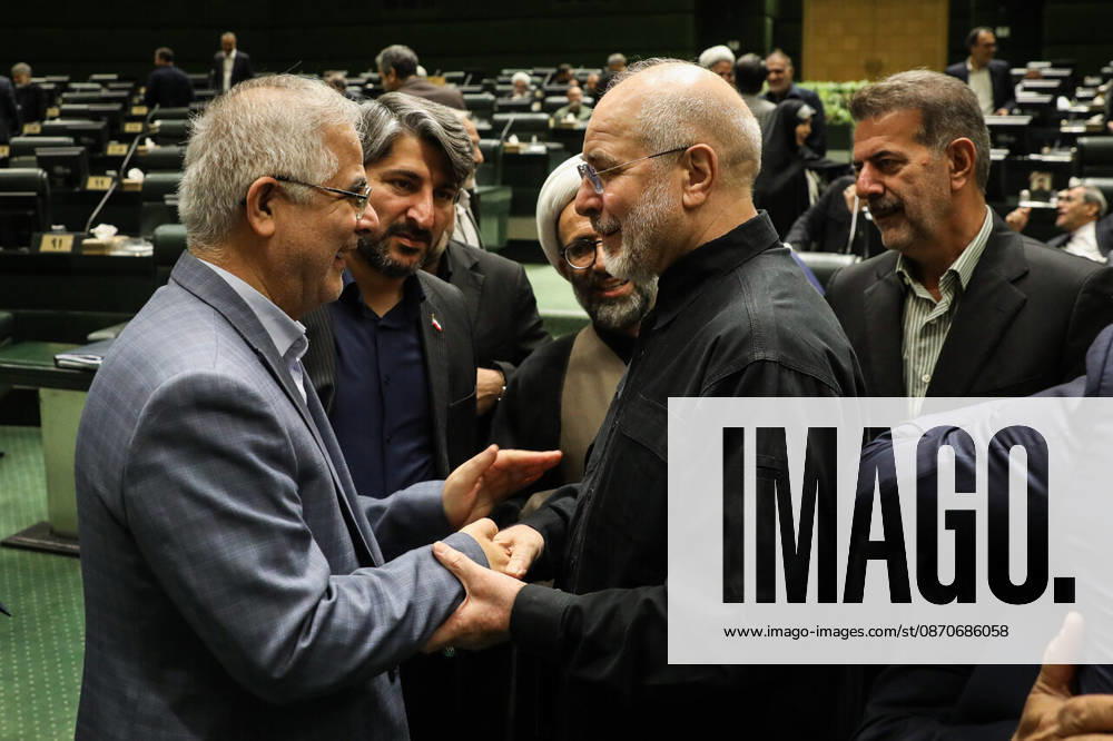 A gray-haired man clasps Mohammad Bagher Ghalibaf s hands in greeting as other lawmakers watch behind them at the Islamic Consultative Assembly in Tehran, Iran, on October 25, 2026. Speaker Mohammad Bagher Ghalibaf chaired the October 25 session, which combined physical attendance at the Islamic Consultative Assembly with participation by video link. Tehran Iran - ZUMAi98_ 20261025_zih_i98_071