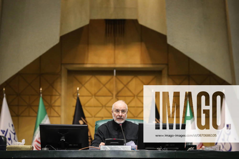 Mohammad Bagher Ghalibaf sits alone at the raised presiding desk, flanked by Iranian and parliamentary flags at the Islamic Consultative Assembly in Tehran, Iran, on October 25, 2026. Speaker Mohammad Bagher Ghalibaf chaired the October 25 session, which combined physical attendance at the Islamic Consultative Assembly with participation by video link. Tehran Iran - ZUMAi98_ 20261025_zih_i98_086