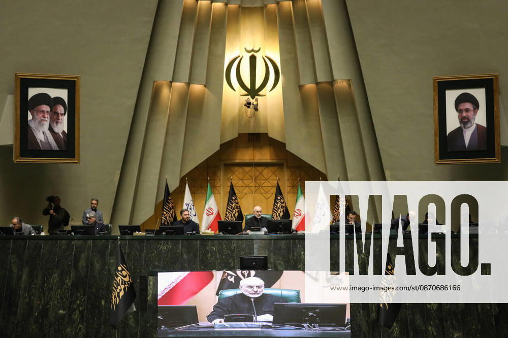 Mohammad Bagher Ghalibaf sits at the raised dais beneath Iran s national emblem, with two framed portraits and flags at the Islamic Consultative Assembly in Tehran, Iran, on October 25, 2026. Speaker Mohammad Bagher Ghalibaf chaired the October 25 session, which combined physical attendance at the Islamic Consultative Assembly with participation by video link. Tehran Iran - ZUMAi98_ 20261025_zih_i98_102
