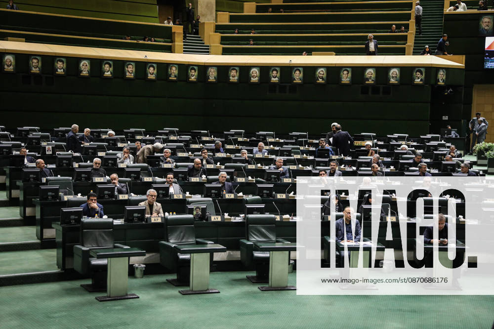 A broad view of the parliamentary hall shows members dispersed across banks of green seats and desk monitors at the Islamic Consultative Assembly in Tehran, Iran, on October 25, 2026. The Islamic Consultative Assembly resumed an open sitting in its Tehran chamber with a mix of in-person and remote participation, according to parliamentary reporting. Tehran Iran - ZUMAi98_ 20261025_zih_i98_106
