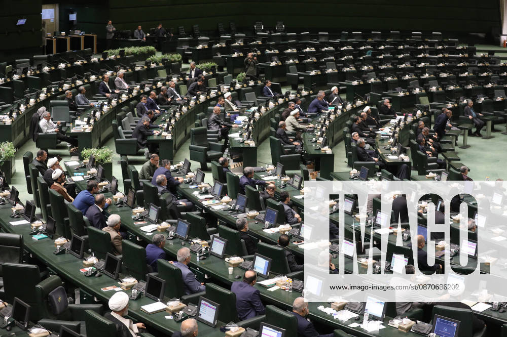 A wide view shows lawmakers seated at curved rows of green desks with a number of members raising their hands at the Islamic Consultative Assembly in Tehran, Iran, on October 25, 2026. The Islamic Consultative Assembly resumed an open sitting in its Tehran chamber with a mix of in-person and remote participation, according to parliamentary reporting. Tehran Iran - ZUMAi98_ 20261025_zih_i98_120