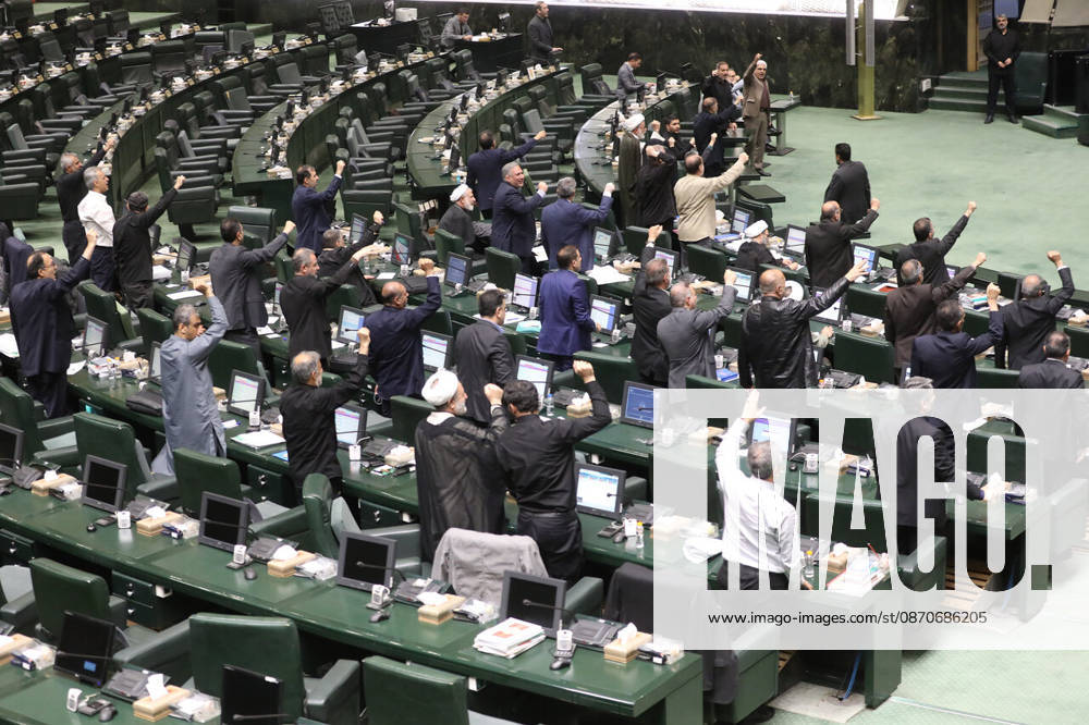 A section of the chamber s curved seating shows numerous lawmakers raising their hands over their desk monitors at the Islamic Consultative Assembly in Tehran, Iran, on October 25, 2026. The Islamic Consultative Assembly resumed an open sitting in its Tehran chamber with a mix of in-person and remote participation, according to parliamentary reporting. Tehran Iran - ZUMAi98_ 20261025_zih_i98_122