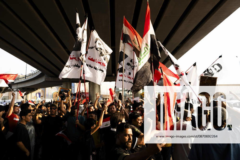 Najaf Iraq October Protest Protesters carrying flags gather beneath an overpass during a demonstration in Najaf, Iraq on October 25, 2026. The protest marked the seventh anniversary of the October 2019 protest movement, with participants calling for political reform, anti-corruption measures, improved public services and more jobs. Najaf Najaf Iraq