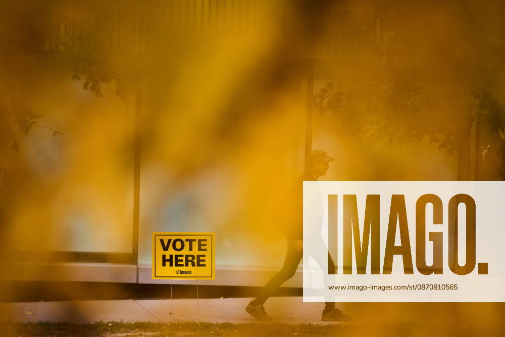 People pass election signage as they head to the polls to vote in Toronto s municipal election, on Monday, Oct. 26, 2026. Toronto Canada - ZUMAc35_ 20261026_zaf_c35_044