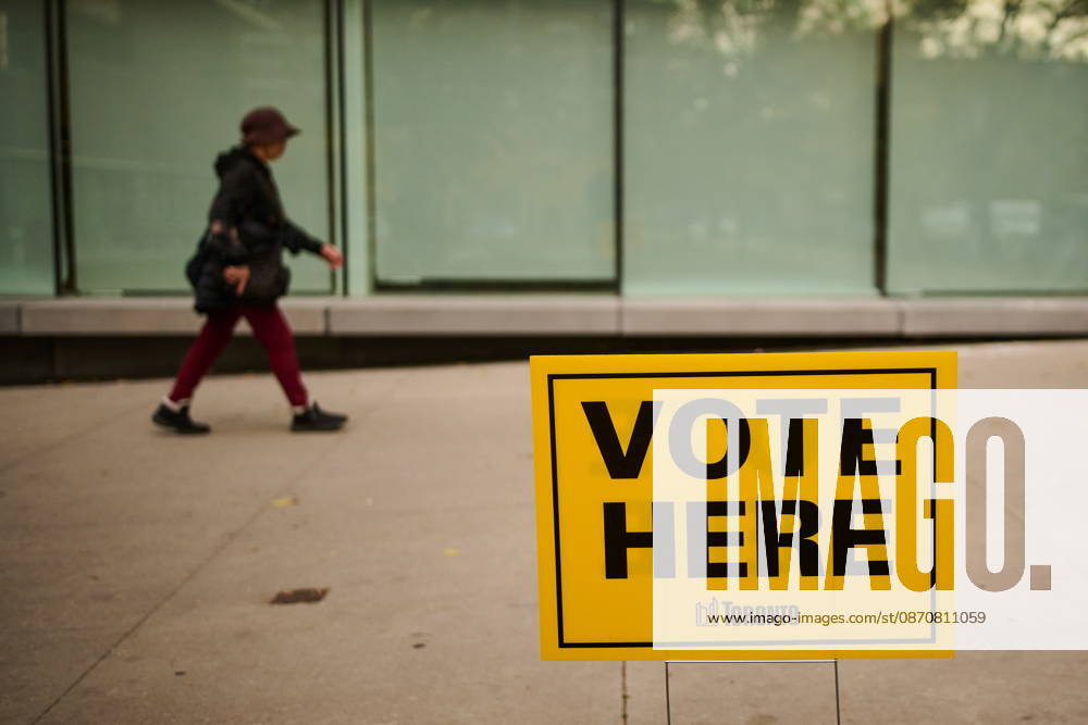 People pass election signage as they head to the polls to vote in Toronto s municipal election, on Monday, Oct. 26, 2026. Toronto Canada - ZUMAc35_ 20261026_zaf_c35_046