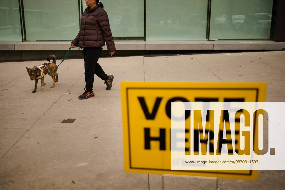 People pass election signage as they head to the polls to vote in Toronto s municipal election, on Monday, Oct. 26, 2026. Toronto Canada - ZUMAc35_ 20261026_zaf_c35_047