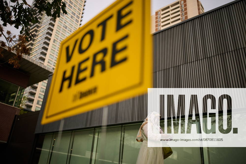 People pass election signage as they head to the polls to vote in Toronto s municipal election, on Monday, Oct. 26, 2026. Toronto Canada - ZUMAc35_ 20261026_zaf_c35_048