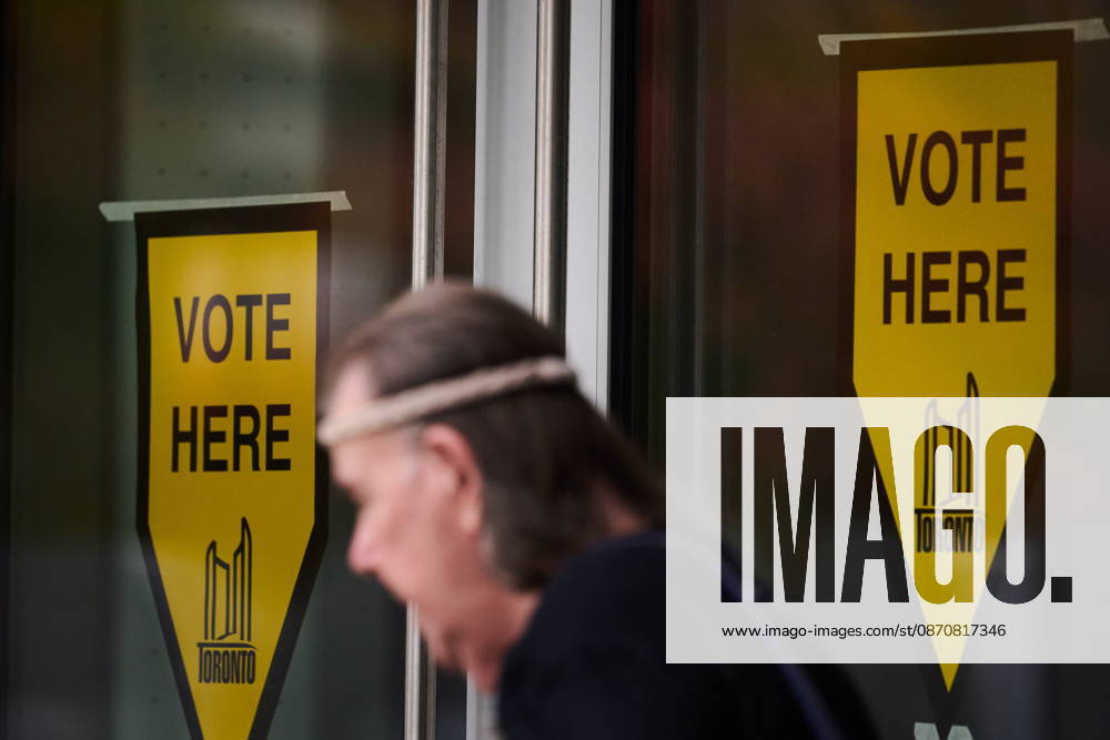 A person passes election signage as they head to the polls to vote in Toronto s municipal election, on Monday, Oct. 26, 2026. Toronto Canada - ZUMAc35_ 20261026_zaf_c35_069