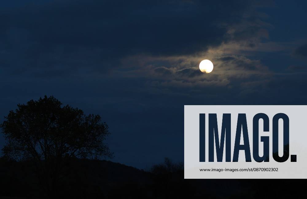 Full Moon, October 26, 2026, Bachra—the full moon emerges from the clouds in the evening sky