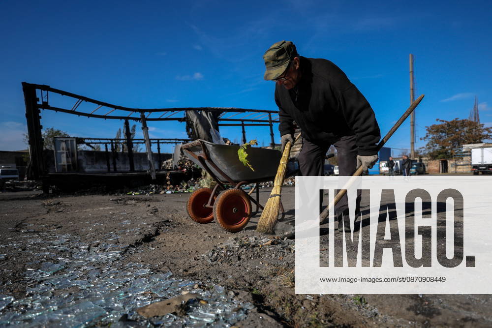 RUSSIA, DONETSK - OCTOBER 27, 2026: A man clears shards and debris on the premises of a motor transport enterprise after a Ukrainian drone strike on the city Donetsk Russia - ZUMAt113 20261027_zaa_t113_130