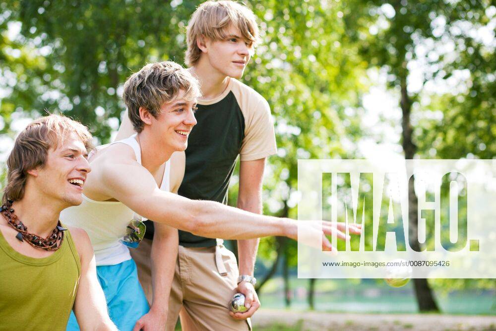 Friends playing boule model released Symbolfoto