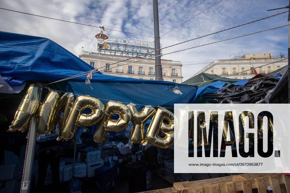 Balloons spelling out Happy Birthday are displayed among tents at Madrids Puerta del Sol..The encampment at Madrids Puerta del Sol has reached its one-month mark. Hundreds of tents remain set up by housing rights activists, who organized the occupation of the square in response to the eviction of Maricarmen a woman in her eighties carried out by a real estate investment fund. Madrid Spain - ZUMAs197 20261027_aaa_s197_162