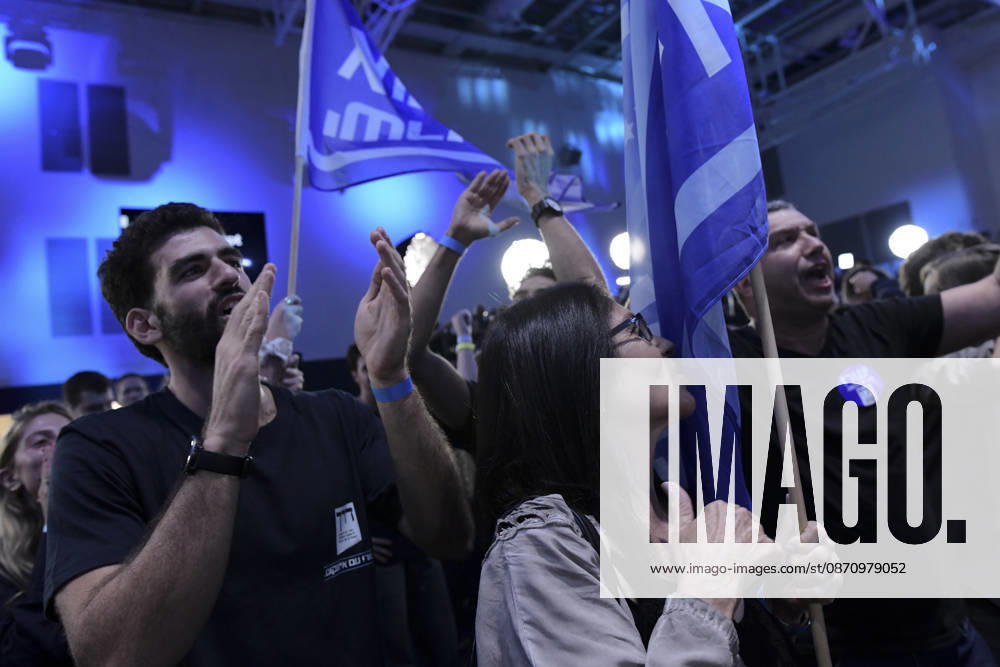 Yashar Supporters Celebrate Exit Polls A man claps beside a woman holding a Yashar party flag as another supporter raises an arm and shouts in Tel Aviv, Israel, on October 27, 2026. Supporters of Yashar, the party led by former Israeli military chief Gadi Eisenkot, gathered in Tel Aviv as initial exit polls were released following voting in the 26th Knesset election. Tel Aviv Tel Aviv Israel