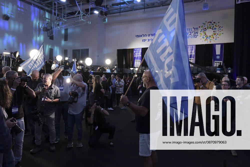 Yashar Supporters Celebrate Exit Polls A supporter waves a Yashar party flag as photographers and other attendees gather near the media area during the party s election-night event in Tel Aviv, Israel, on October 27, 2026. Supporters of Yashar, the party led by former Israeli military chief Gadi Eisenkot, gathered in Tel Aviv as initial exit polls were released following voting in the 26th Knesset election. Tel Aviv Tel Aviv Israel