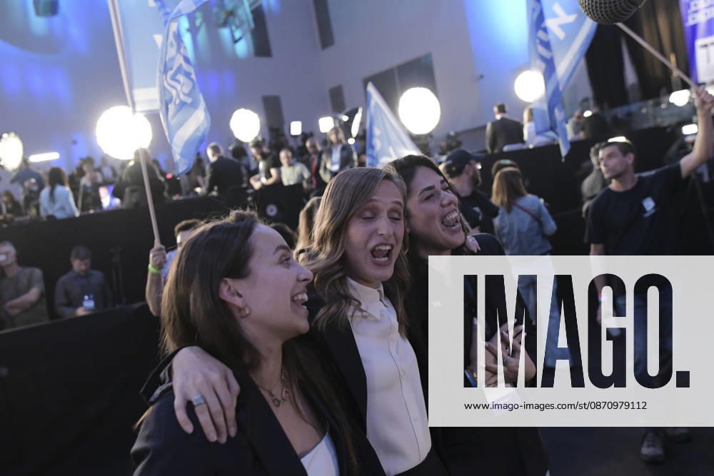 Yashar Supporters Celebrate Exit Polls Three women put their arms around one another and cheer amid waving Yashar party flags at an election-night gathering in Tel Aviv, Israel, on October 27, 2026. Supporters of Yashar, the party led by former Israeli military chief Gadi Eisenkot, gathered in Tel Aviv as initial exit polls were released following voting in the 26th Knesset election. Tel Aviv Tel Aviv Israel
