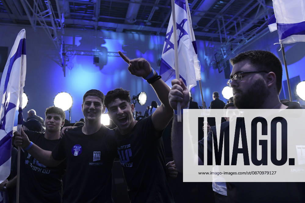 Yashar Supporters Celebrate Exit Polls A group of young men cheer and raise their arms while another supporter holds an Israeli flag at the Yashar party election-night gathering in Tel Aviv, Israel, on October 27, 2026. Supporters of Yashar, the party led by former Israeli military chief Gadi Eisenkot, gathered in Tel Aviv as initial exit polls were released following voting in the 26th Knesset election. Tel Aviv Tel Aviv Israel