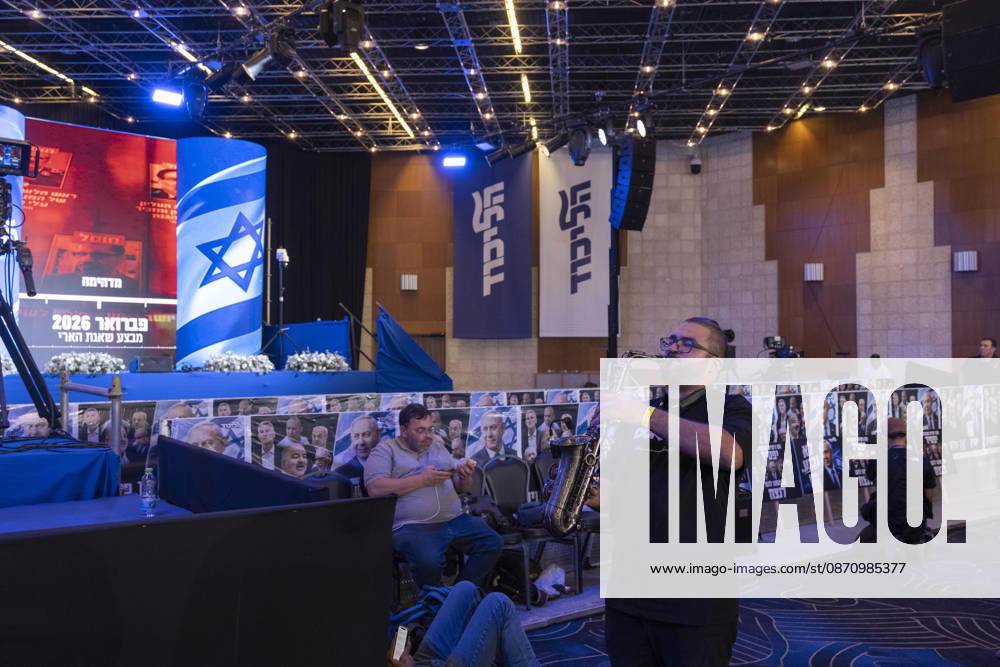 Likud Supporters Await Netanyahu Appearance A musician plays a saxophone in front of Likud banners and a stage decorated with portraits of Israeli Prime Minister Benjamin Netanyahu at the party headquarters in Tel Aviv, Israel, on October 28, 2026. Party supporters and journalists gathered following the release of television exit polls, which projected Likud to be the largest party in the 120-seat Knesset but showed neither major bloc securing the 61 seats needed for a majority. Tel Aviv Tel Aviv Israel