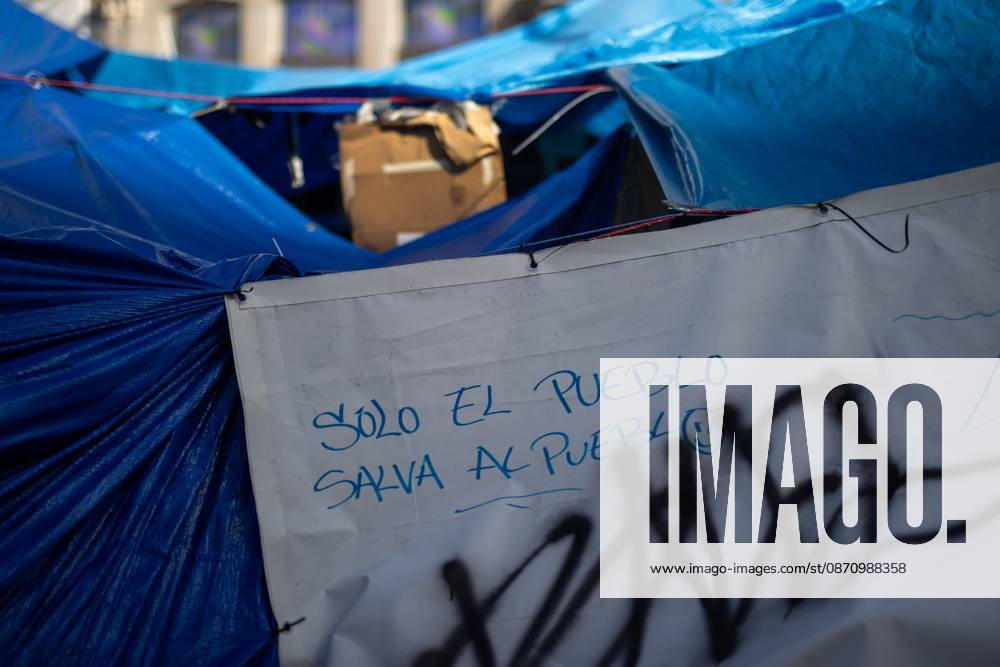 Puerta del Sol Encampment in Madrid, Spain - 27 Oct 2026 Graffiti reading Only the people can save the people is visible among tents at Madrid’s Puerta del Sol. The encampment at Madrid’s Puerta del Sol has reached its one-month mark. Hundreds of tents remain set up by housing rights activists, who organized the occupation of the square in response to the eviction of Maricarmen—a woman in her eighties—carried out by a real estate investment fund. Madrid Spain