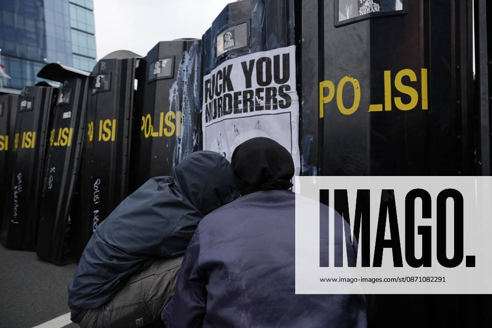 Student protesters crouch in front of police riot shields bearing a poster reading Fuck You Murderers during a demonstration at Bundaran HI Jakarta Indonesia - ZUMAm265 20261028_zip_m265_018