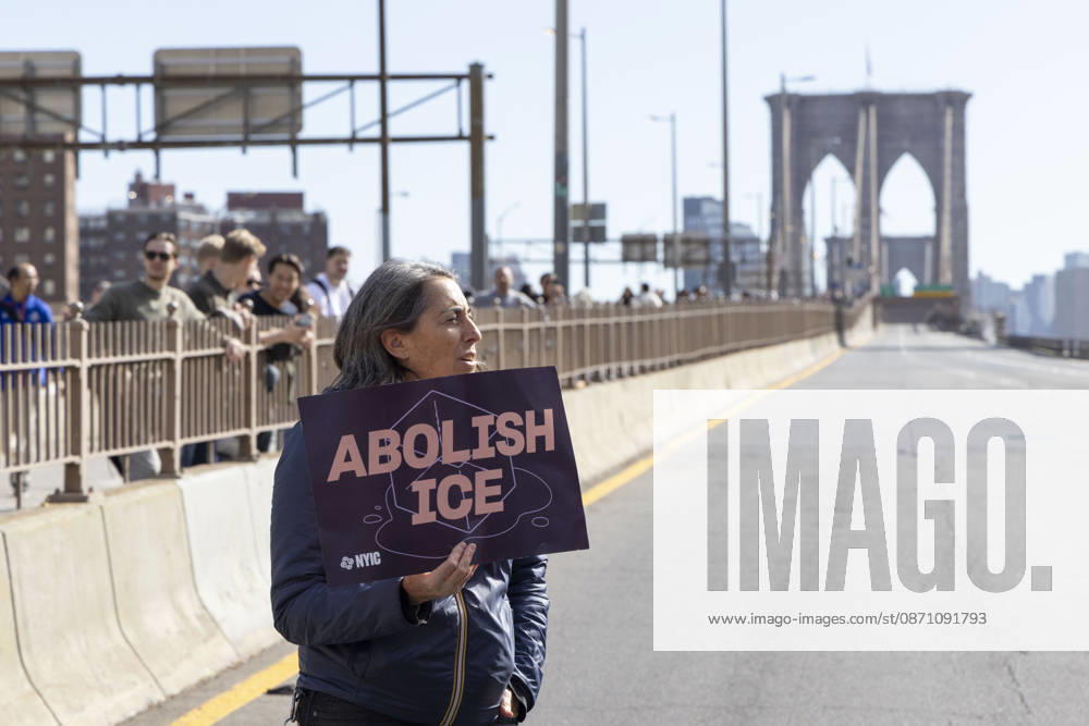 Anti-ICE (U.S. Immigration and Customs Enforcement) demonstrators blockade the roadway on the Brooklyn Bridge holding signs that read ABOLISH ICE protesting the continued detainment of O. Belgal, who was shot by federal agents in the Bronx with his 5-yr-old son in the car. The demonstration stopped Brooklyn bound traffic and results in arrests by NYPD. Protesters call for ICE out of New York. New York USA - ZUMAr174 20261028_znp_r174_009