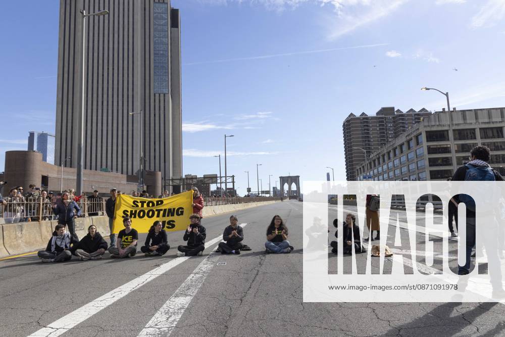 Anti-ICE (U.S. Immigration and Customs Enforcement) demonstrators blockade the roadway on the Brooklyn Bridge with a banner that reads STOP SHOOTING US protesting the continued detainment of O. Belgal, who was shot by federal agents in the Bronx with his 5-yr-old son in the car. The demonstration stopped Brooklyn bound traffic and results in arrests by NYPD. Protesters call for ICE out of New York. New York USA - ZUMAr174 20261028_znp_r174_015