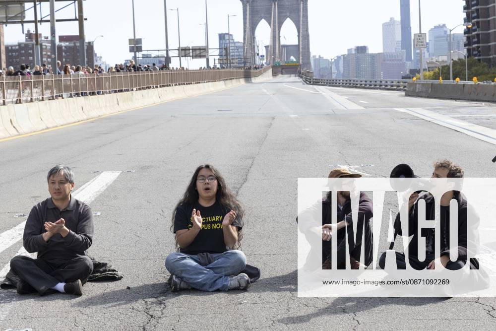 Anti-ICE (U.S. Immigration and Customs Enforcement) demonstrators sit in the roadway on the Brooklyn Bridge protesting the continued detainment of O. Belgal, who was shot by federal agents in the Bronx with his 5-yr-old son in the car. The demonstration stopped Brooklyn bound traffic and results in arrests by NYPD. Protesters call for ICE out of New York. New York USA - ZUMAr174 20261028_znp_r174_014
