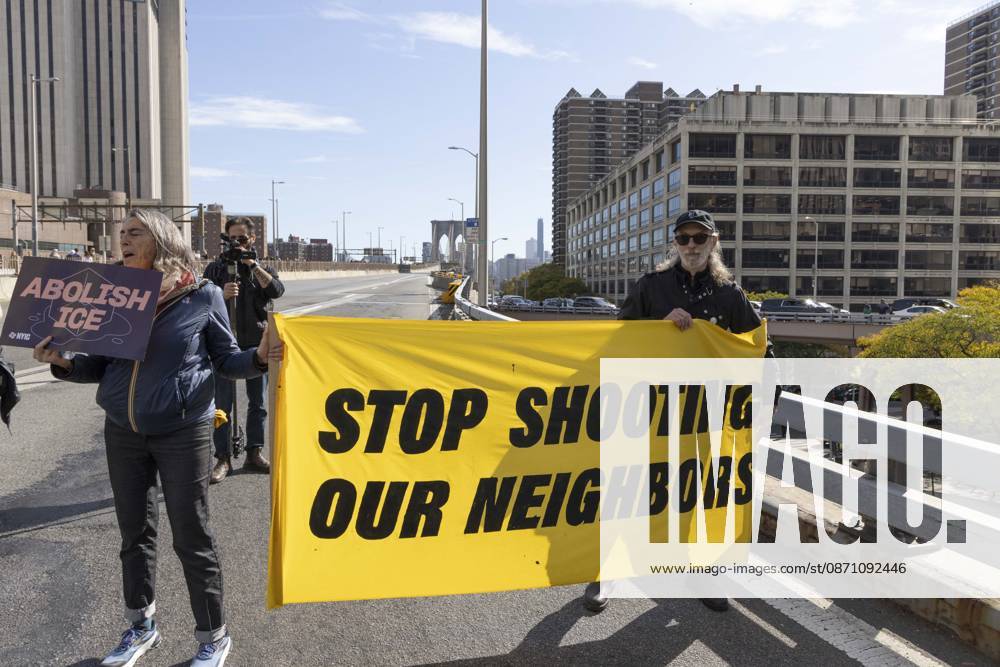 Anti-ICE (U.S. Immigration and Customs Enforcement) demonstrators blockade the roadway on the Brooklyn Bridge with signs and banners that read STOP SHOOTING OUR NEIGHBORS ABOLISH ICE protesting the continued detainment of O. Belgal, who was shot by federal agents in the Bronx with his 5-yr-old son in the car. The demonstration stopped Brooklyn bound traffic and results in arrests by NYPD. Protesters call for ICE out of New York. New York USA - ZUMAr174 20261028_znp_r174_018