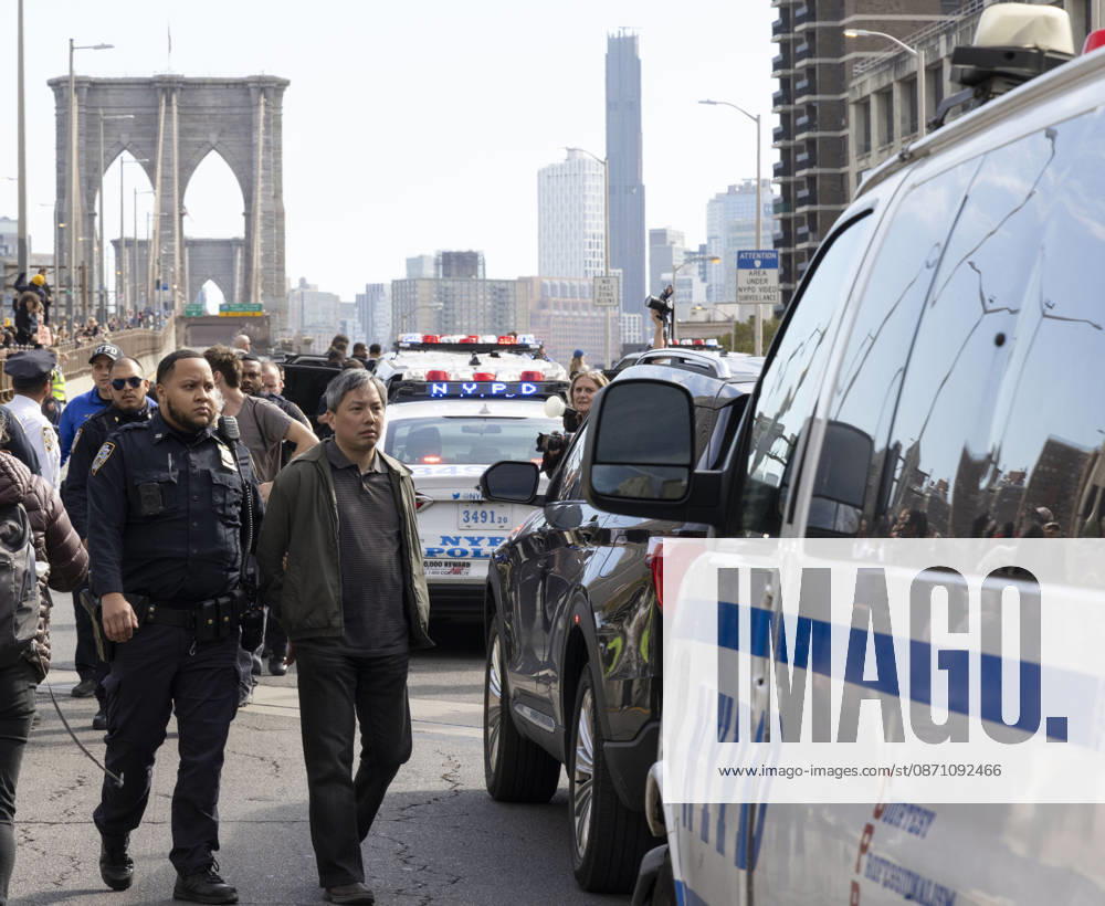 Anti-ICE (U.S. Immigration and Customs Enforcement) demonstrators are arrested by NYPD after blockading the roadway and stopping traffic on the Brooklyn Bridge protesting the continued detainment of O. Belgal, who was shot by federal agents in the Bronx with his 5-yr-old son in the car. Protesters call for ICE out of New York. New York USA - ZUMAr174 20261028_znp_r174_024