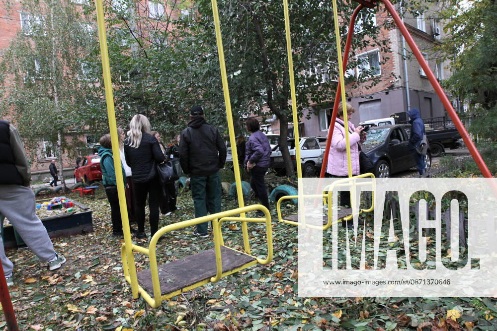 People stay at a playground outside an apartment block on Oleksandra Polia Avenue damaged by a Russian drone strike in Dnipro, Ukraine, on October 30, 2026. The Russian attack damaged at least five residential high-rise buildings and a school. More than 300 windows were shattered in the strike. (Photo by Mykola Miakshykov Ukrinform) Russian attack damages residential buildings and school in Dnipro