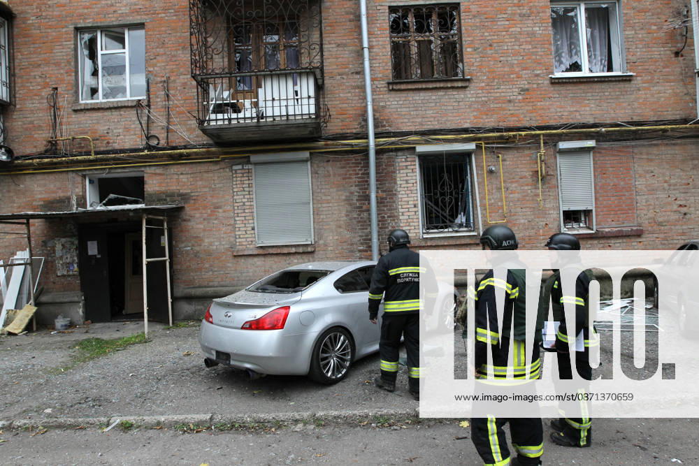 A rescuer approaches a car parked outside an apartment block on Oleksandra Polia Avenue damaged by a Russian drone strike in Dnipro, Ukraine, on October 30, 2026. The Russian attack damaged at least five residential high-rise buildings and a school. More than 300 windows were shattered in the strike. (Photo by Mykola Miakshykov Ukrinform) Russian attack damages residential buildings and school in Dnipro