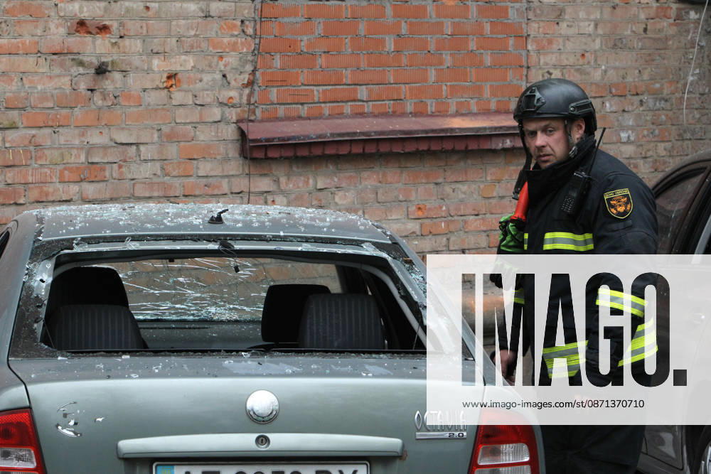 A rescuer approaches a car parked outside an apartment block on Oleksandra Polia Avenue damaged by a Russian drone strike in Dnipro, Ukraine, on October 30, 2026. The Russian attack damaged at least five residential high-rise buildings and a school. More than 300 windows were shattered in the strike. (Photo by Mykola Miakshykov Ukrinform) Russian attack damages residential buildings and school in Dnipro
