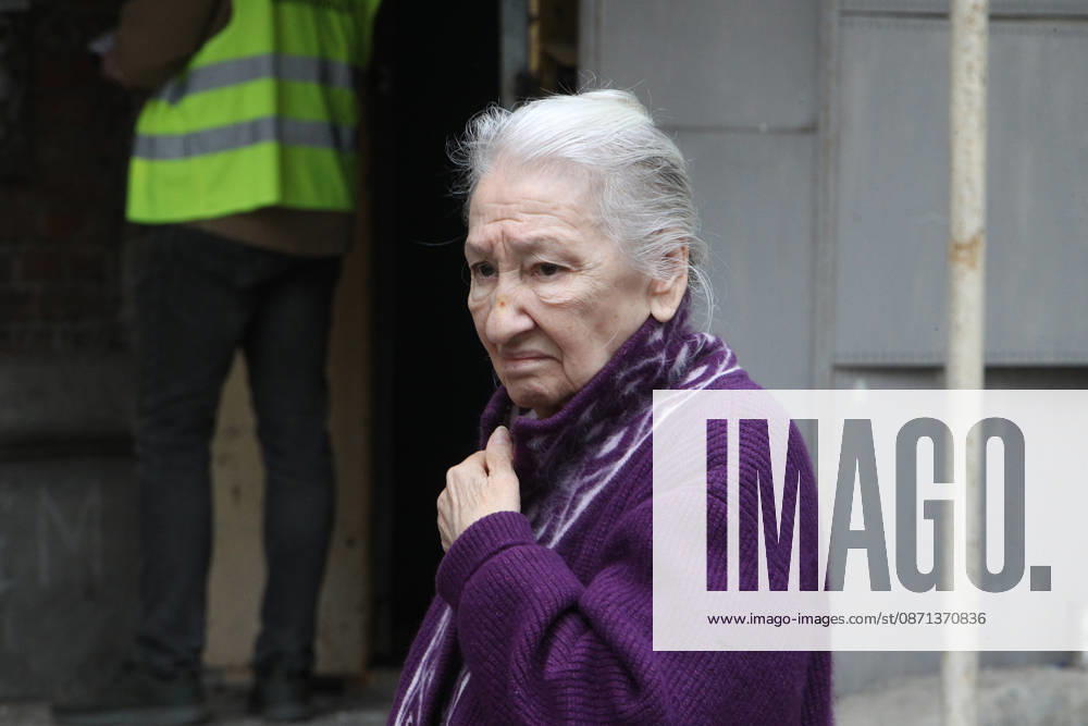 An elderly woman stands outside an apartment block on Oleksandra Polia Avenue damaged by a Russian drone strike in Dnipro, Ukraine, on October 30, 2026. The Russian attack damaged at least five residential high-rise buildings and a school. More than 300 windows were shattered in the strike. (Photo by Mykola Miakshykov Ukrinform) Russian attack damages residential buildings and school in Dnipro
