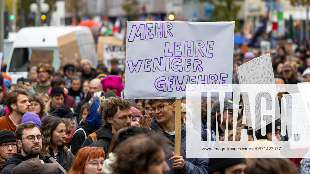 Gen Z Takes Charge: Hundreds March Through the Old Town and Südstadt, Nuremberg, October 31, 2026 Participants in the Gen Z Takes Charge initiative march through the city carrying homemade signs; one sign calls for More Education, fewer guns. The nationwide initiative calls for more fundi 20261031-1V9A3941-M4000