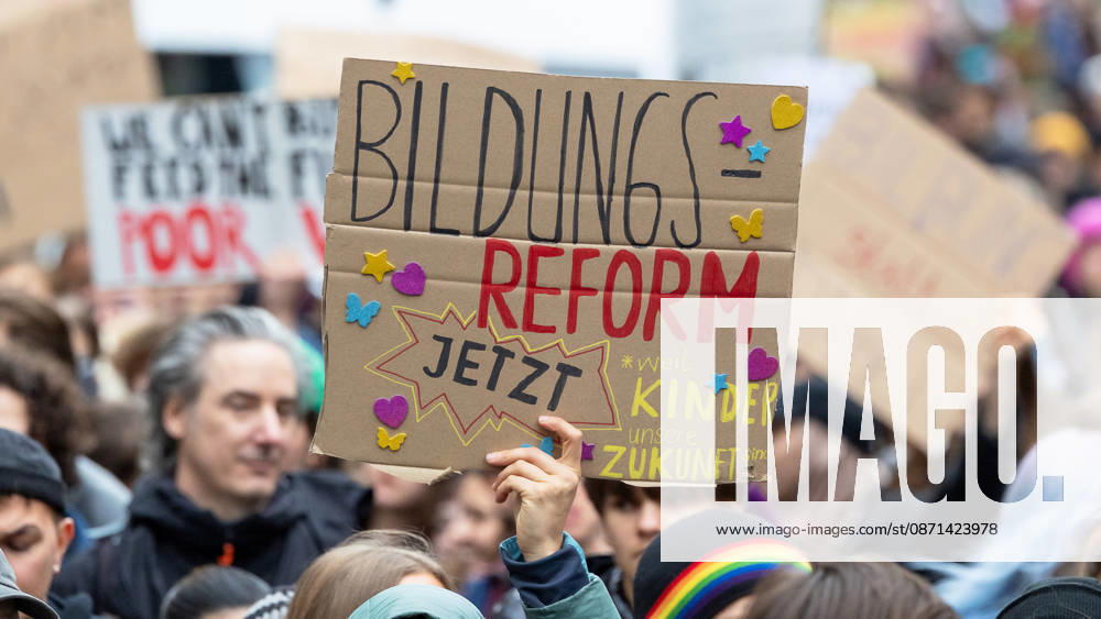 Gen Z Regelt: Hundreds March Through the Old Town and Südstadt, Nuremberg, October 31, 2026. At the demonstration organized by the Gen Z Regelt initiative, a participant holds up a cardboard sign reading Education Reform Now. The nationwide initiative is calling for more funding for education and hea 20261031-1V9A3944-M4000