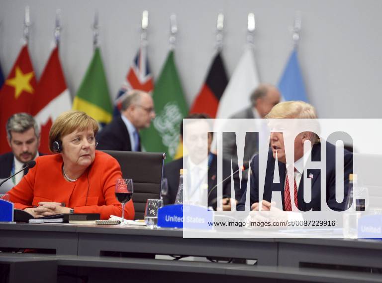 Buenos Aires, Argentina - German Chancellor ANGELA MERKEL, left, listens as U.S. President DONALD TRUMP address the plenary session on Day Two of the G20 Summit meeting, at the Costa Salguero Center. Buenos Aires Argentina - ZUMA 20181201_mda_p138_049