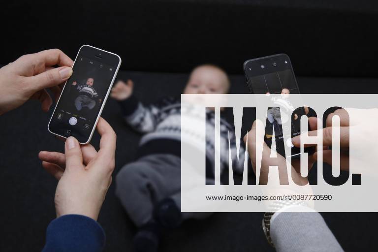 A baby is photographed with two smartphones MODEL RELEASE available Model release available MODEL RELEASED Berlin 16 01 2018 Berlin Germany