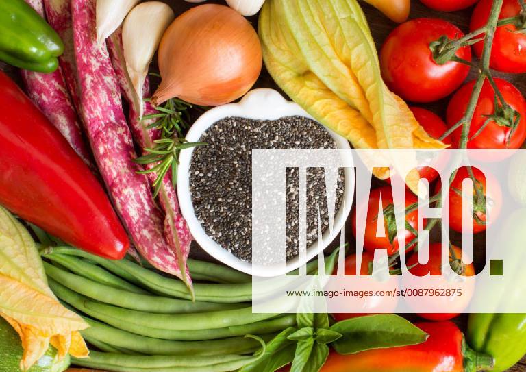 Raw chia seeds in bowl and vegetables