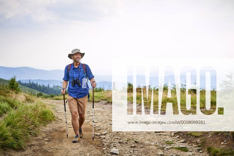 Smiling man hiking in the mountains model released Symbolfoto BSZF00693