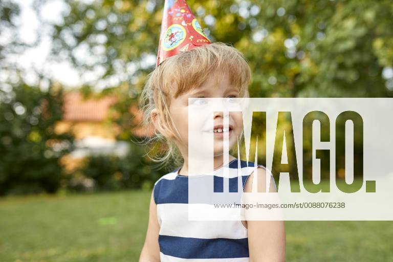 Portrait of little girl on a birthday garden party wearing party hat model released Symbolfoto property released ZEDF01654