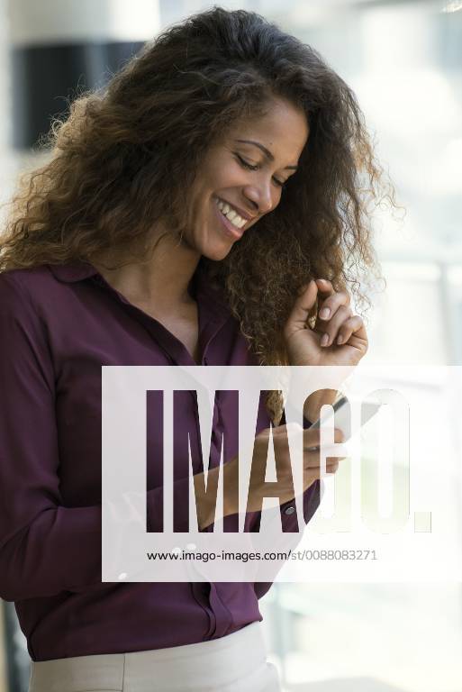 Woman using smartphone, smiling