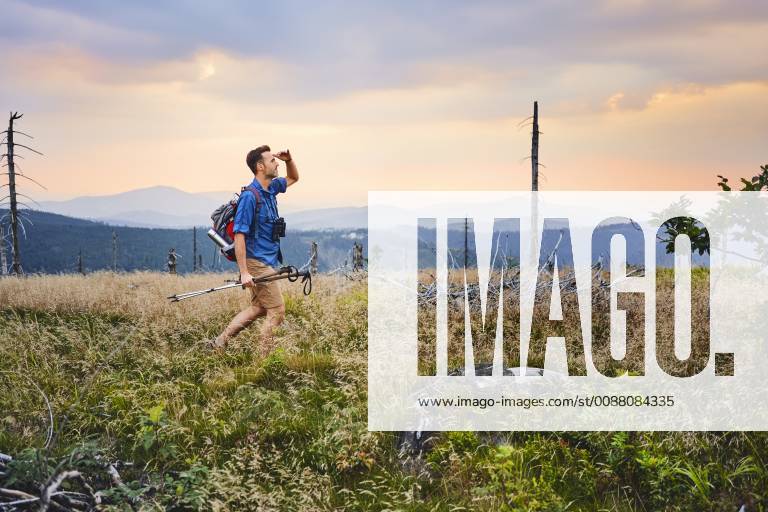 Man hiking in the mountains at dusk model released Symbolfoto BSZF00754