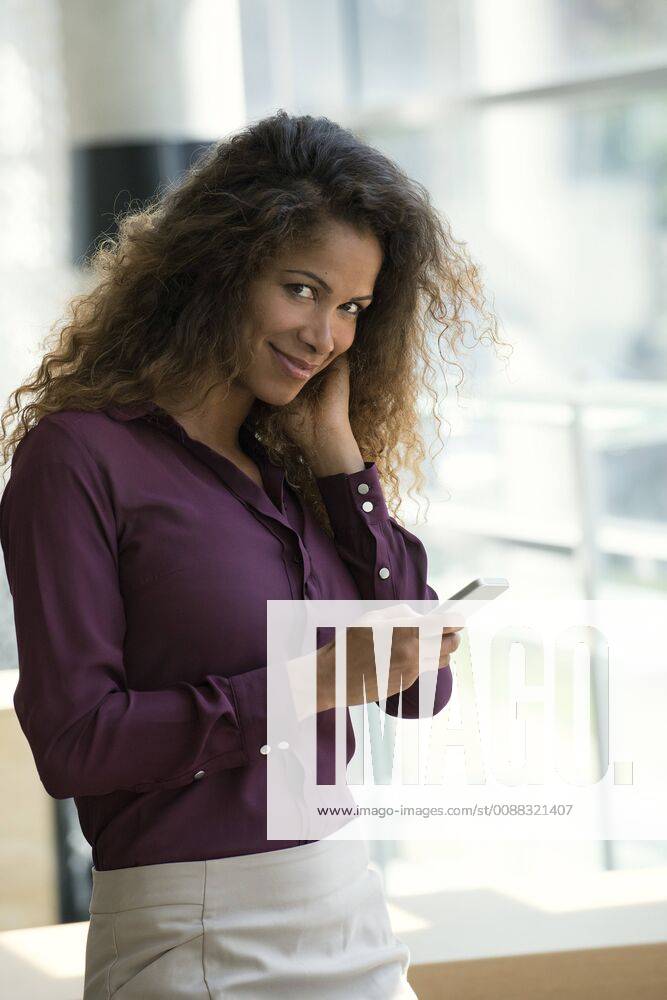 Woman using smartphone, smiling