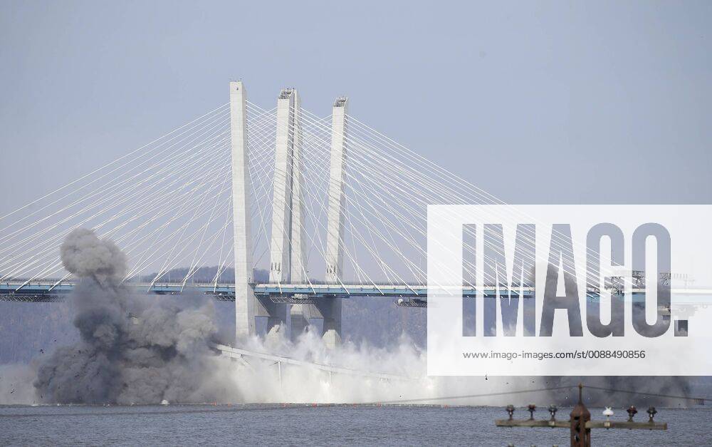 The new Mario M. Cuomo Bridge stands behind a section of the replaced Tappan Zee Bridge where a controlled explosion sends the span into the Hudson River in Irvington, New York on January 15, 2019. One of the two remaining sections of the old Tappan Zee Bridge across the Hudson River was taken down with controlled explosions Tuesday morning. NYP20190115107 JOHNxANGELILLO