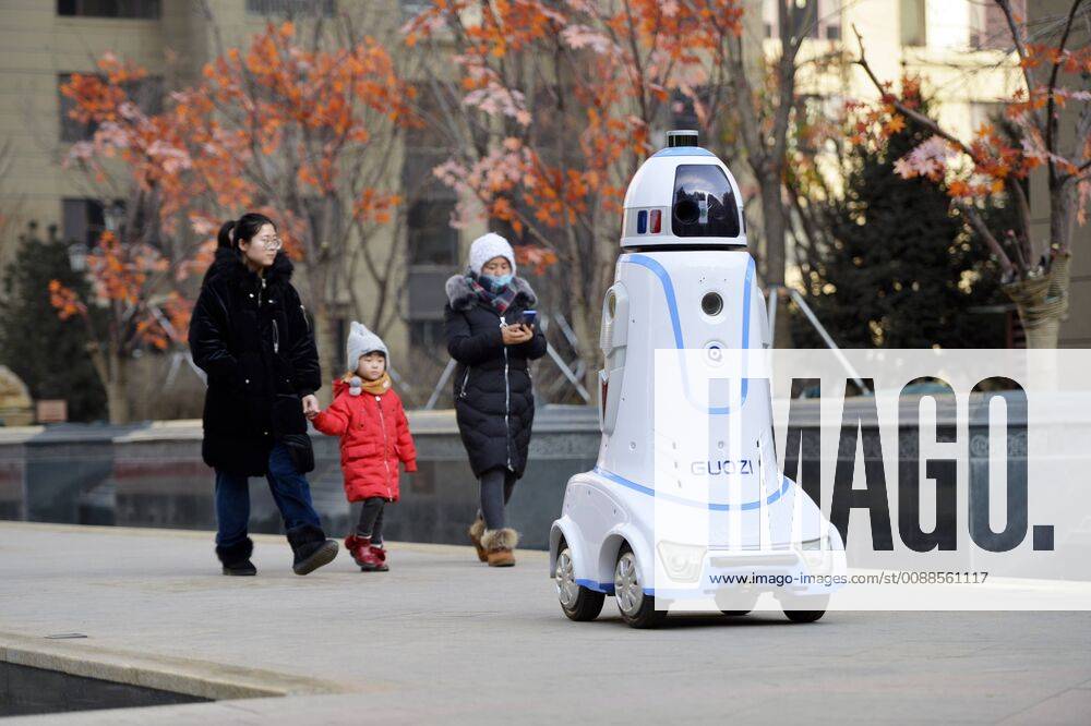 A security robot goes on patrol at a community on January 18, 2019 in Hohhot, Inner Mongolia Autonomous Region of China. The security robots, equipped with panoramic camera and far infrared system, are able to communicate with people, recognize strangers and automatically call the police after noticing something abnormal.