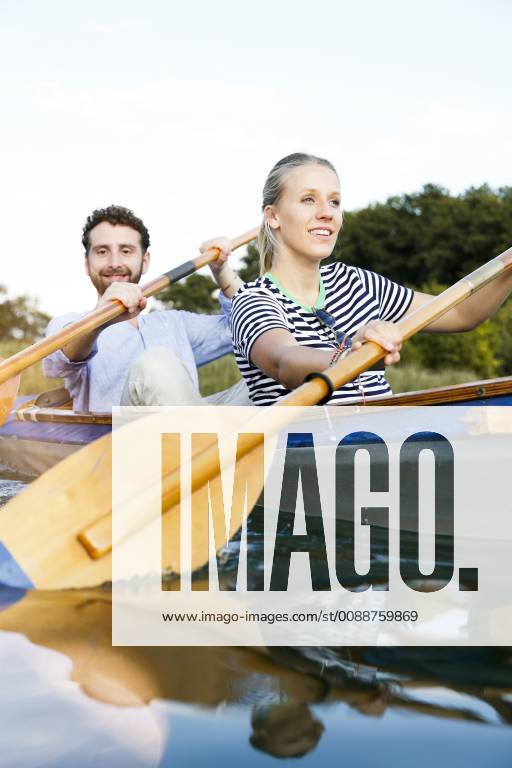 Young couple enjoying a trip in a canoe on a lake model released Symbolfoto FKF02832