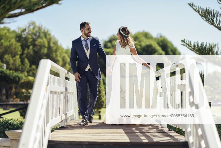 Bridal couple enjoying their wedding day in a park model released Symbolfoto JSMF00570