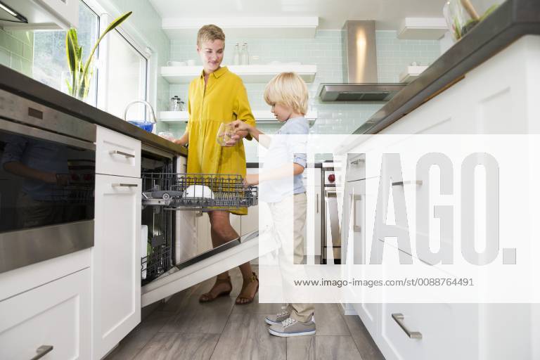 Boy helping mother clearing the dishwasher in kitchen model released Symbolfoto property released MFRF01082