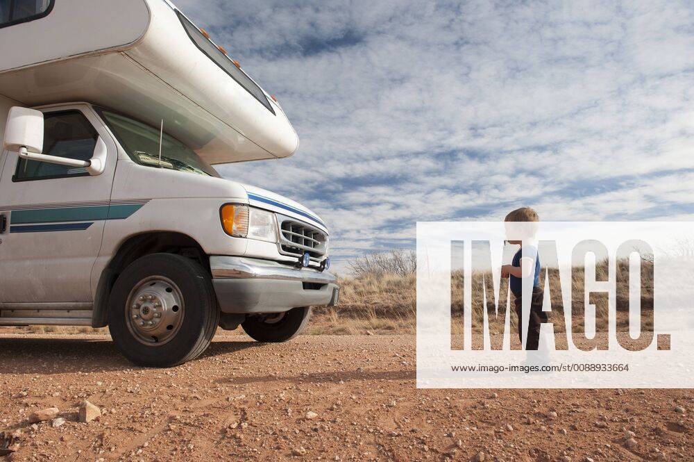 Toddler standing in front of motor home